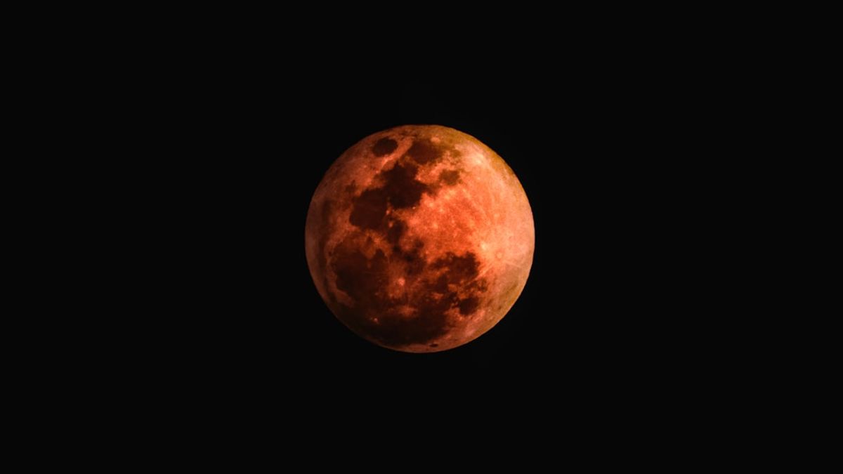 Una luna llena brillante iluminando un paisaje misterioso, sugiriendo una conexión con lo paranormal.